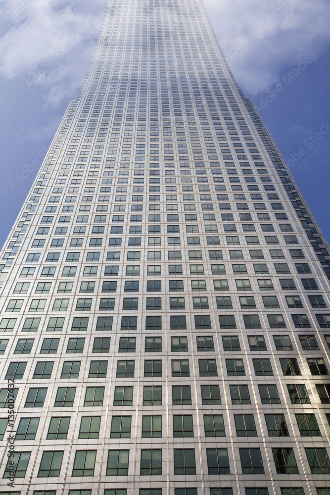 Multistory building covered in clouds on top