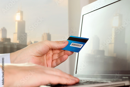 business man entering data of a credit card . On-line shopping o
