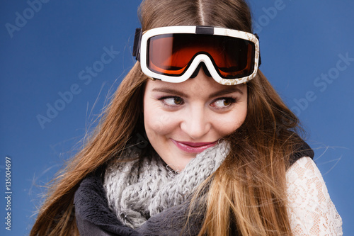 skier girl wearing warm clothes ski googles portrait.