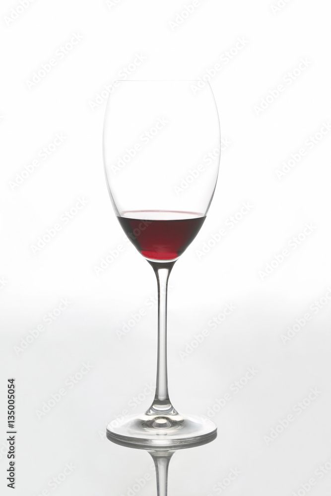 glass with red wine on a light background glass with red wine on a light background