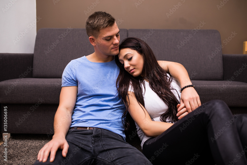 Obraz premium Young lovely couple kissing and hug at home
