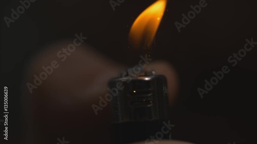 Front shot of lighter lighting macro slow motion