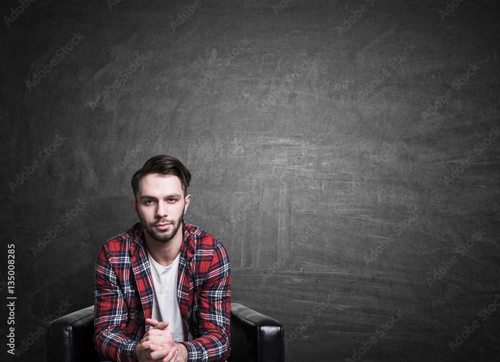 Fototapeta premium Casual guy on chalkboard background