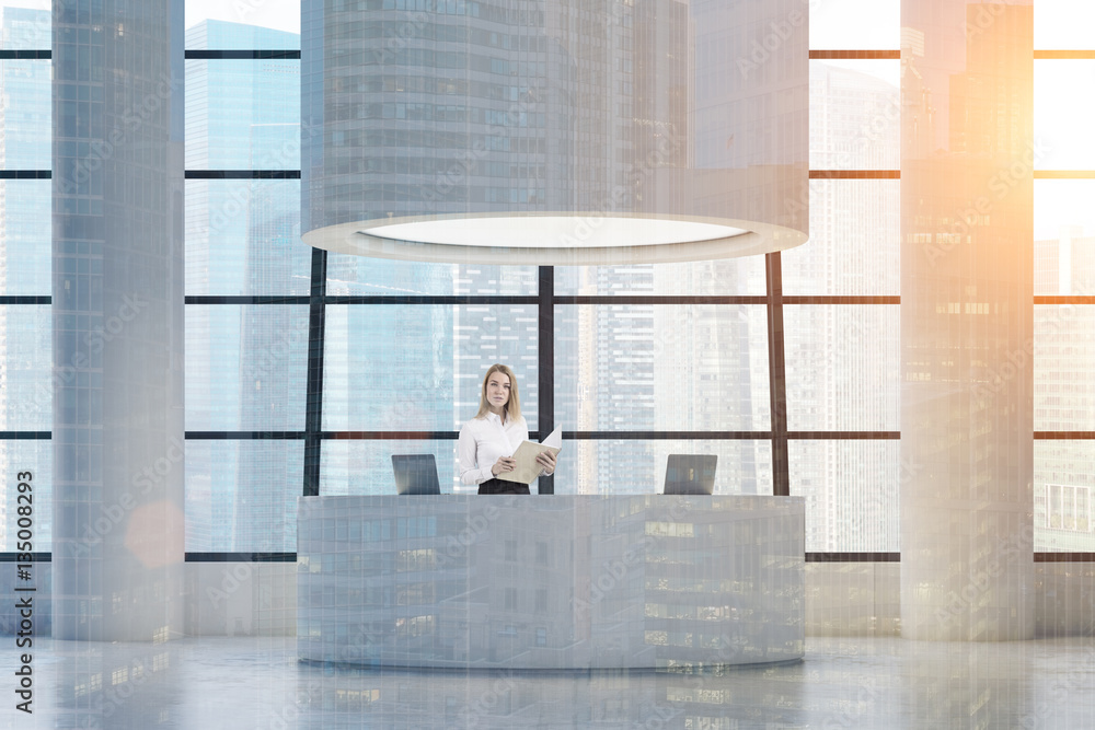 Woman at round reception desk, toned Woman at round reception desk, toned