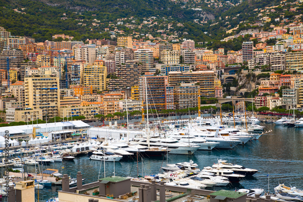 Monaco, Monte Carlo. View of the seaport and the city of Monte Carlo with luxury yachts and sail boats 