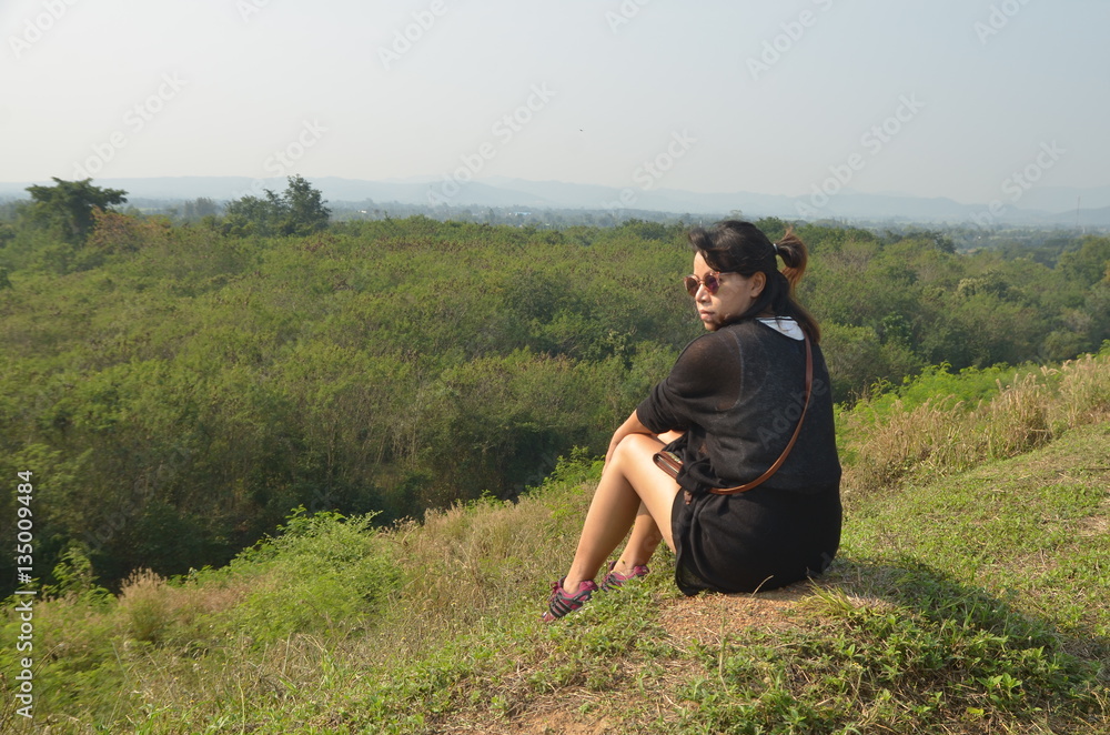woman sit on hill in travel trip 