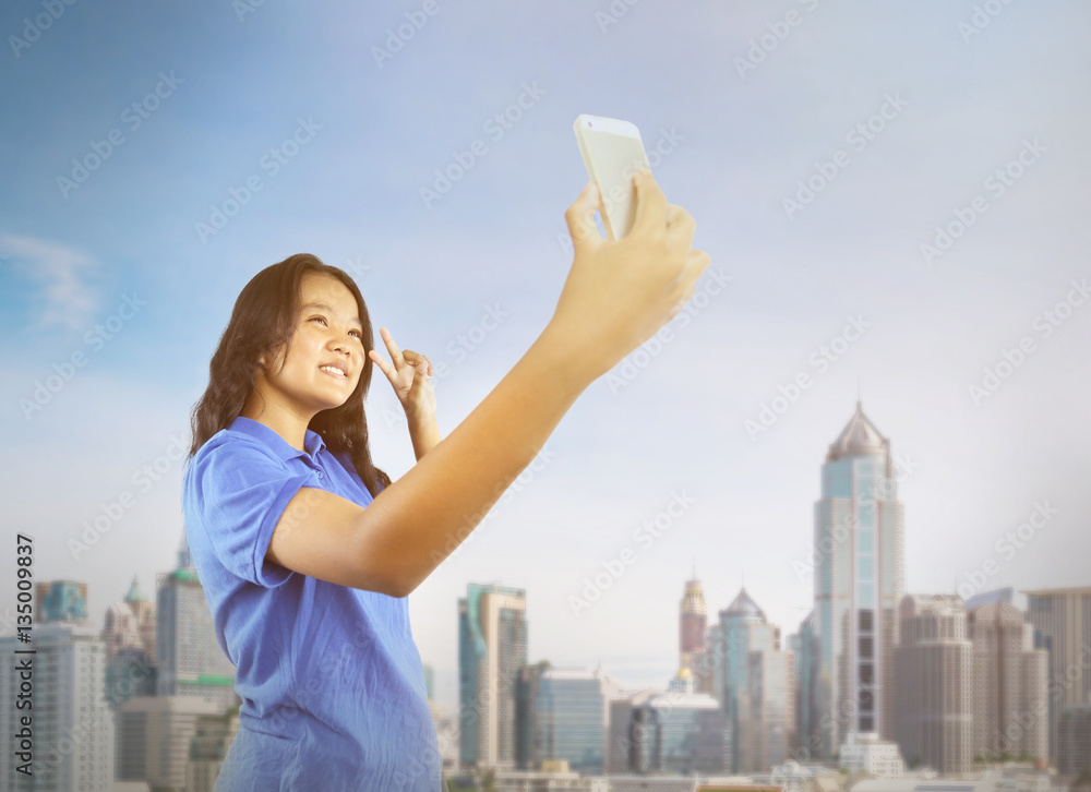 Women selfie herself by mobile phone with city and sky Women selfie herself by mobile phone with city and sky