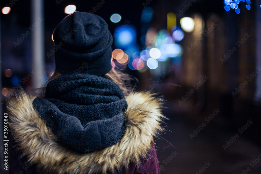 Hipster girl walking on city street at night Hipster girl walking on city street at night