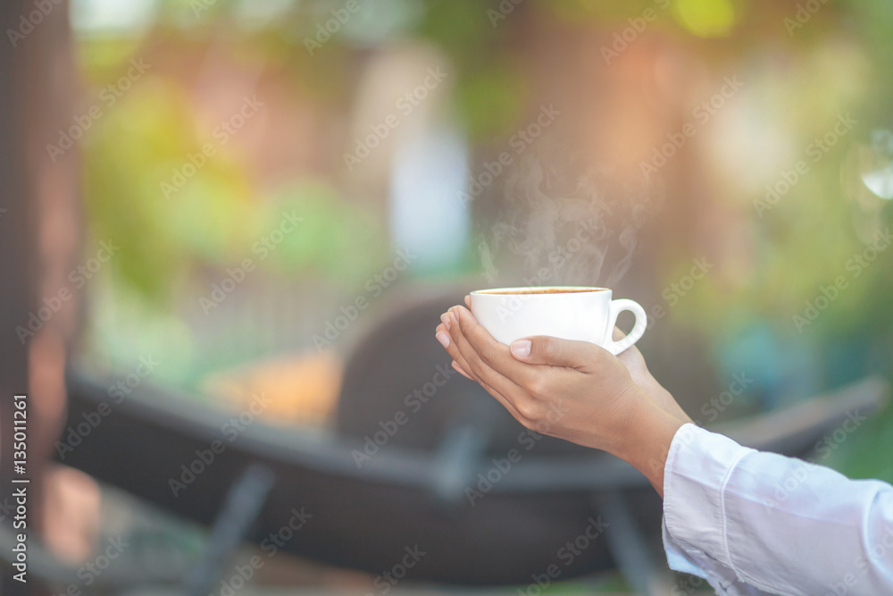 hand holding cup of coffee hand holding cup of coffee