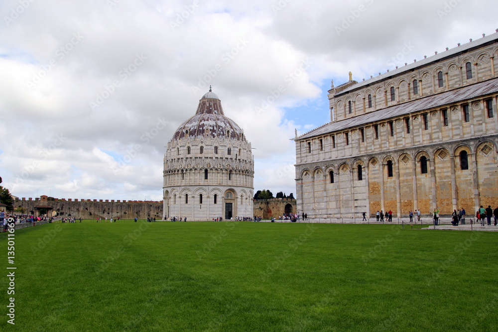 Pisa, Italy. The Pisa Cathedral on the cloudy day with the green grass on the foreground.