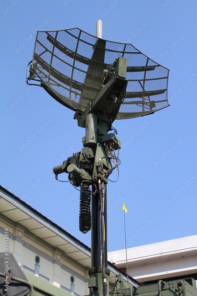 Military radar dish against blue sky Military radar dish against blue sky