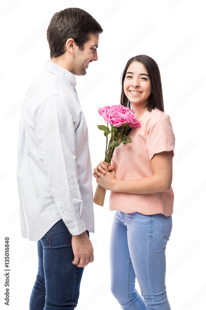 Hispanic girl receiving flowers from a guy Hispanic girl receiving flowers from a guy