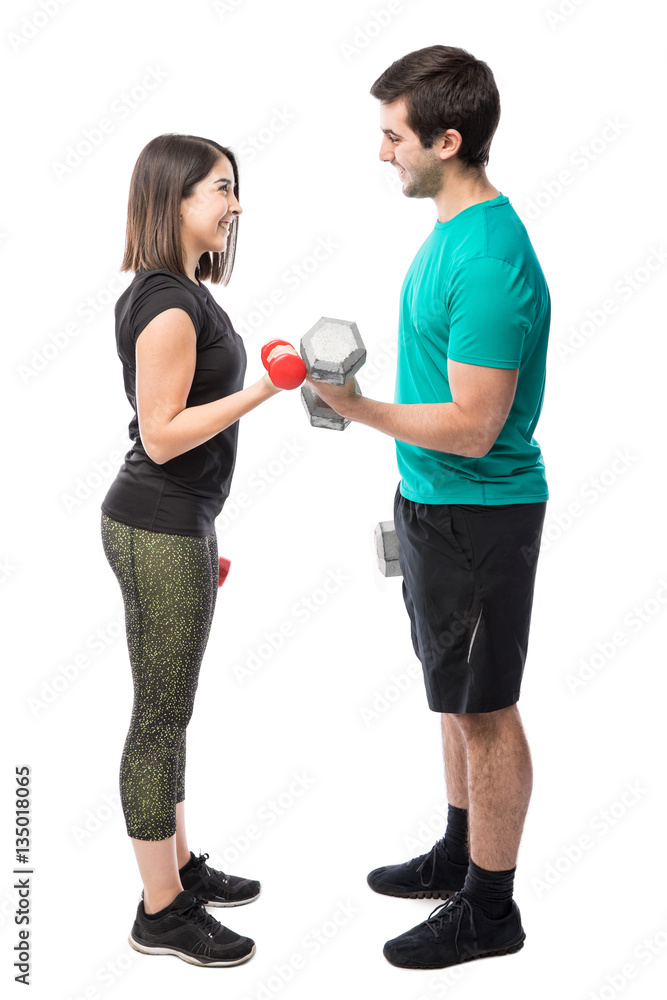 Cute couple doing bicep curls Cute couple doing bicep curls