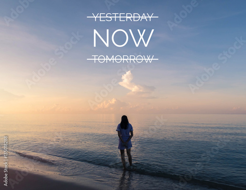 Inspirational quote on silhouette of woman walking on the beach photo