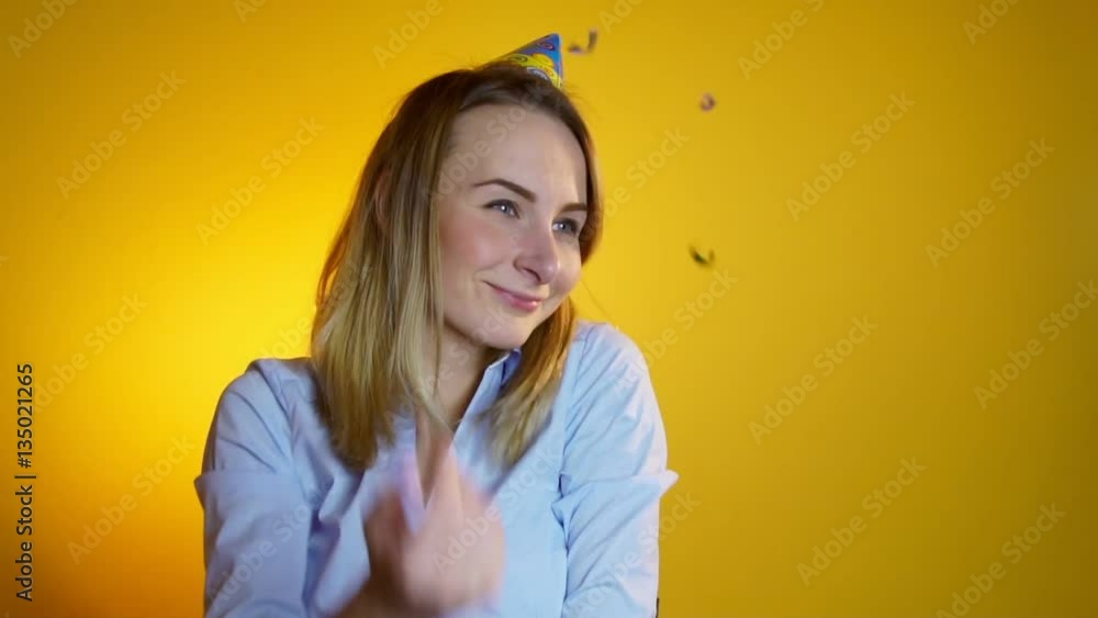 woman launches confetti on a yellow background slow motion woman launches confetti on a yellow background slow motion