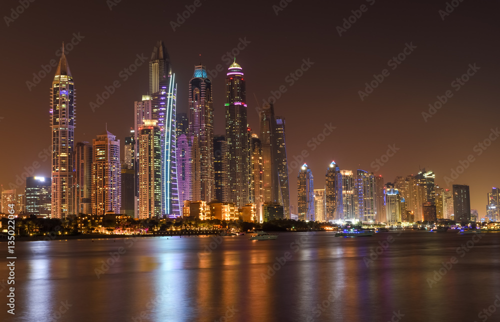 Panoramic night view of Dubai Marina skyscrapers 