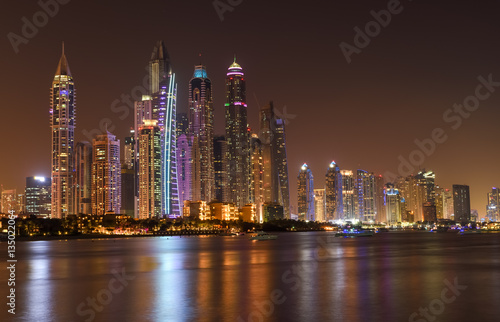 Panoramic night view of Dubai Marina skyscrapers 