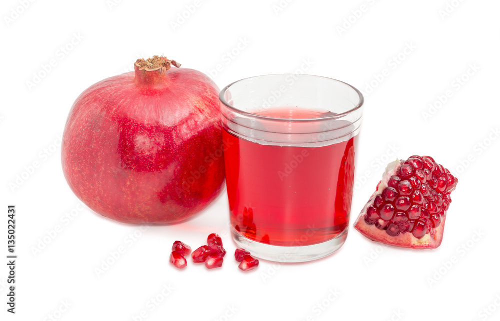 Pomegranate juice in glass, whole and part of split pomegranate Pomegranate juice in glass, whole and part of split pomegranate