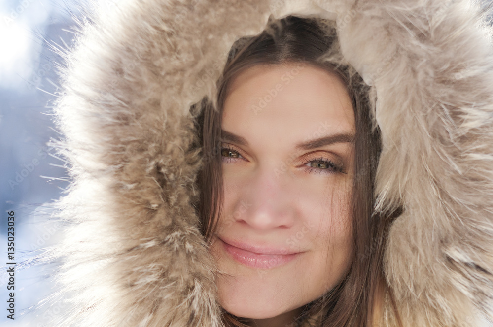 Portrait of a girl in the hood with fur , cold winter Portrait of a girl in the hood with fur , cold winter