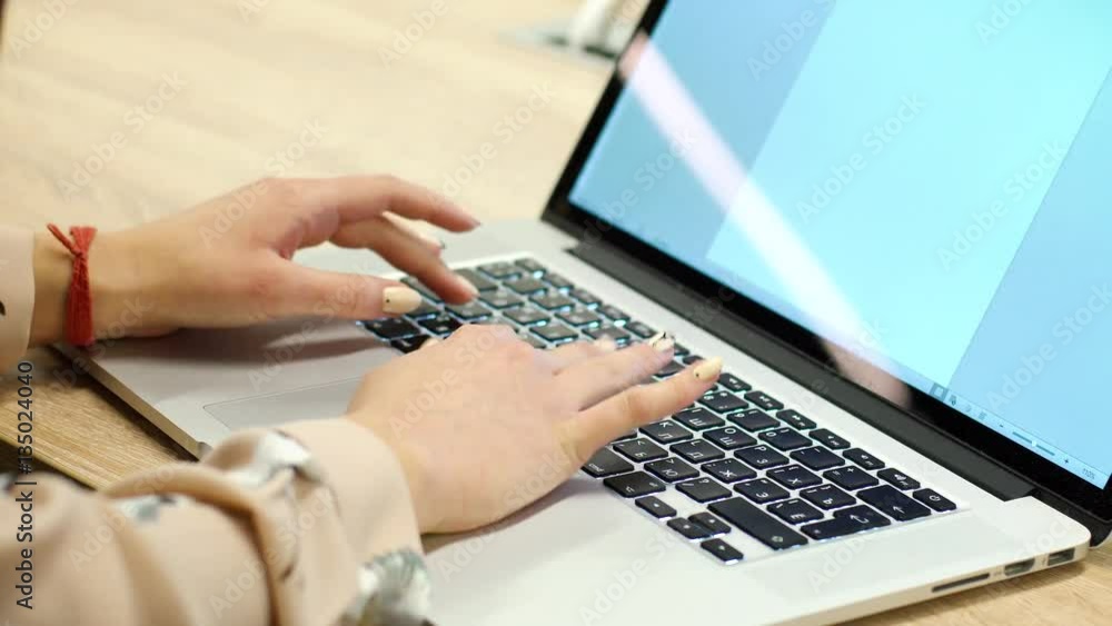 Woman open cover laptop and work with the keyboard backlit.