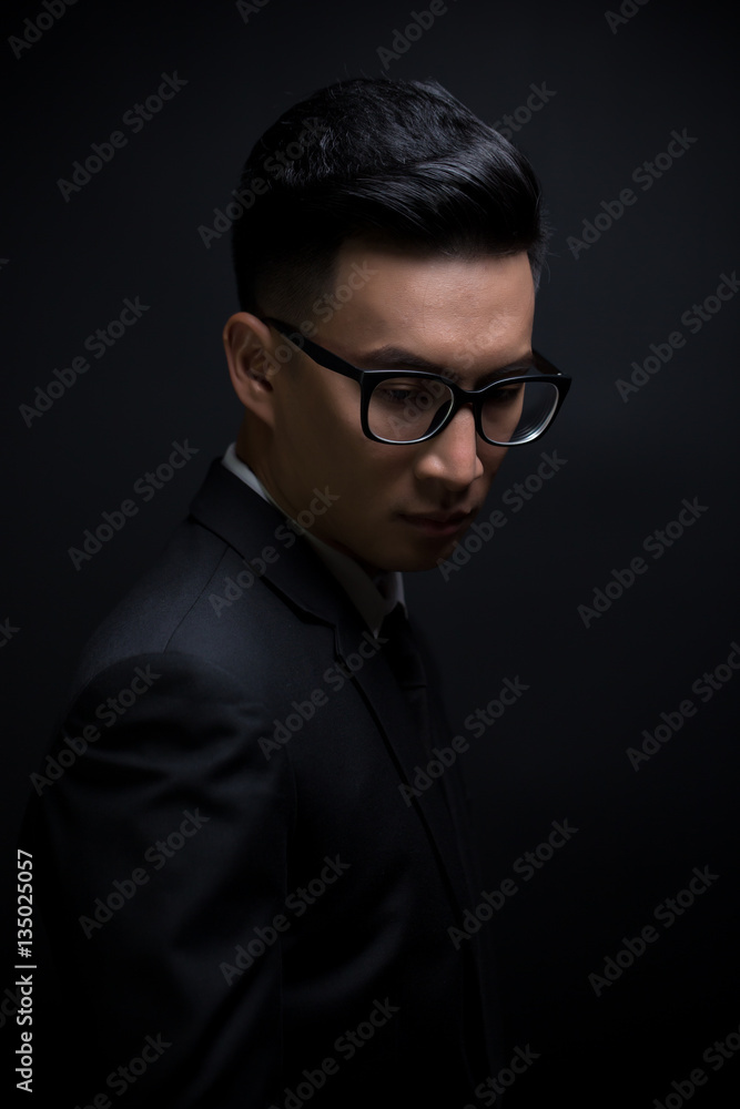 Businessman in black suit on isolated black background Businessman in black suit on isolated black background