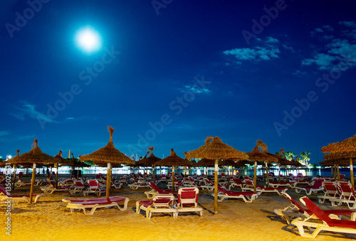 Night beach with sun loungers in Alcudia  Mallorca.