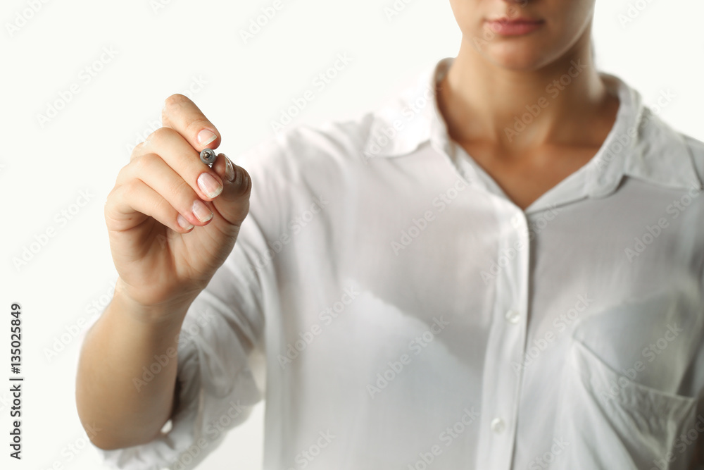 Young businesswoman writing on transparent board against white background Young businesswoman writing on transparent board against white background