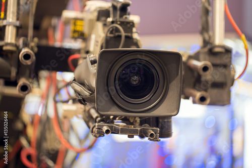 TV professional camera on crane shooting show in studio decoration.