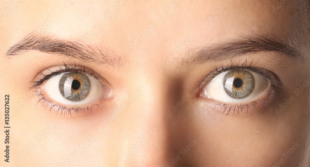 Close up view of a green woman eyes looking at camera