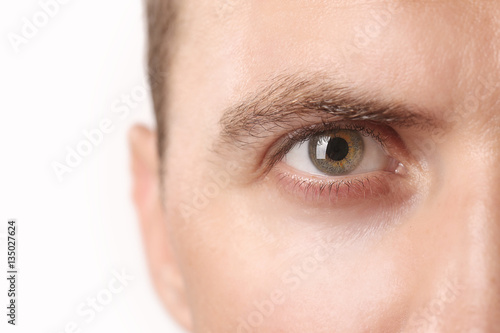 Close up view of a green man's eye looking at camera