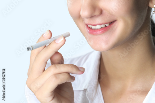 Close up portrait of young woman smoking cigarette  