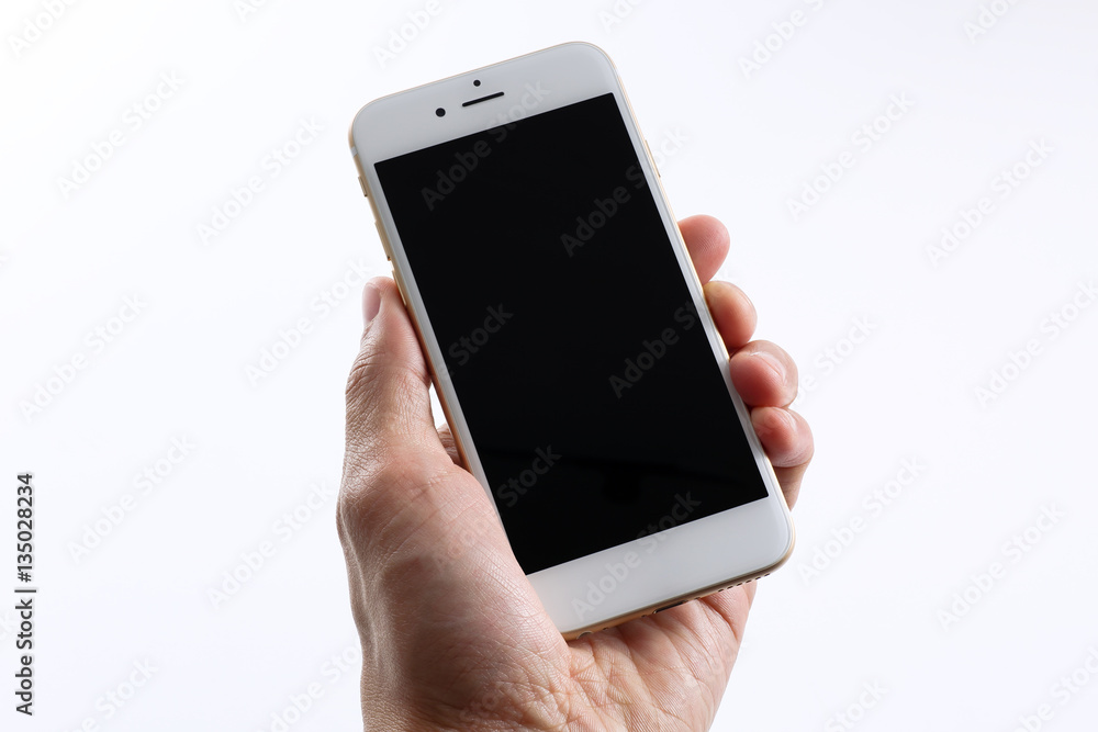Male hand holding white smartphone Male hand holding white smartphone