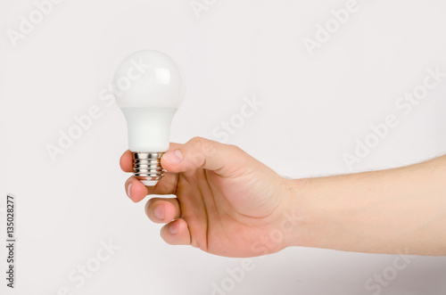 man's hand holding the LED lamp