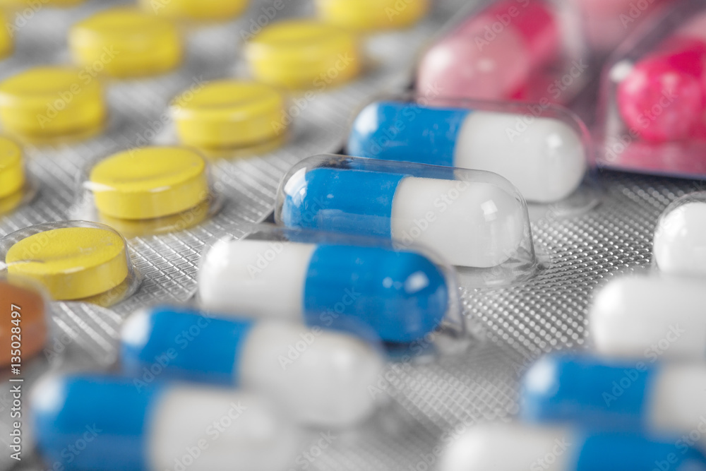 medical pills in different colors in plastic containers medical pills in different colors in plastic containers