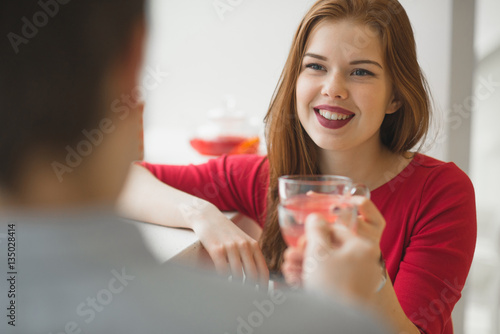 Valentine's Day concept. A loving couple celebrating Valentine's Day in the restaurant. girl's face closeup