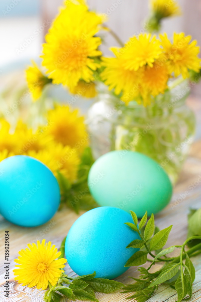 Easter eggs and flowers on wooden background Easter eggs and flowers on wooden background