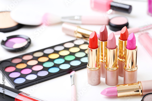 Different makeup cosmetics on white table