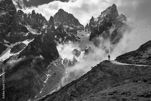 Climber admiring of the landscape of Pale di San Martino, Trentino - Dolomites, Italy. Cimon della Pala mountain ridge. photo