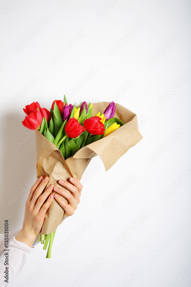 Bouquet of colorful flowers in hands, tulips spring flowers