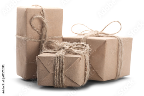 Boxes with gift wrapped in kraft paper on isolated white backgro