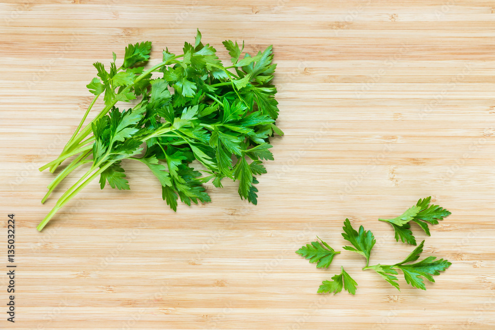 flat leaf parsley leaves on chopping board flat leaf parsley leaves on chopping board