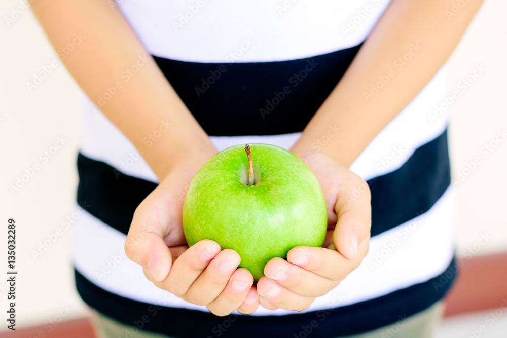 Closeup a fresh green apple in children hands. Closeup a fresh green apple in children hands.