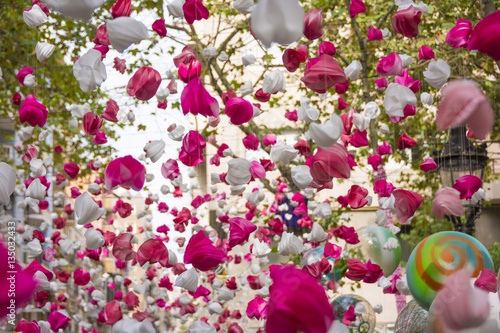 Canvas Print Pink love petals hanging and moving in Gracia district, Barcelona