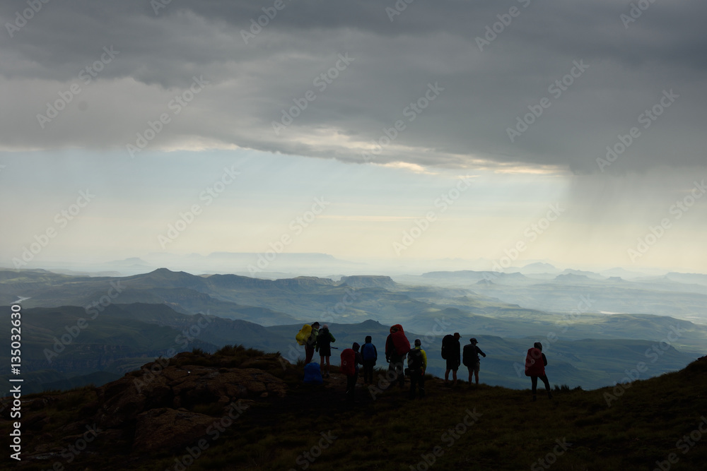 Silhouette hikers on Drakensberg Mountains