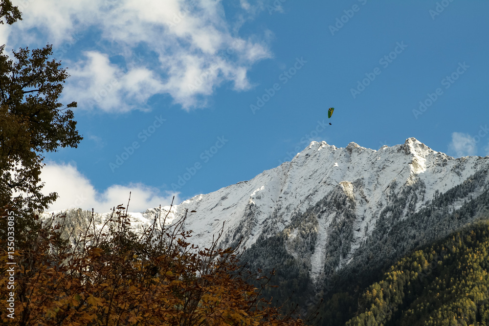 Paraglider In The  Snowy  Mountains Of South Tirol