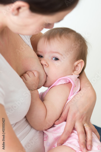 Mom breast feeding baby girl