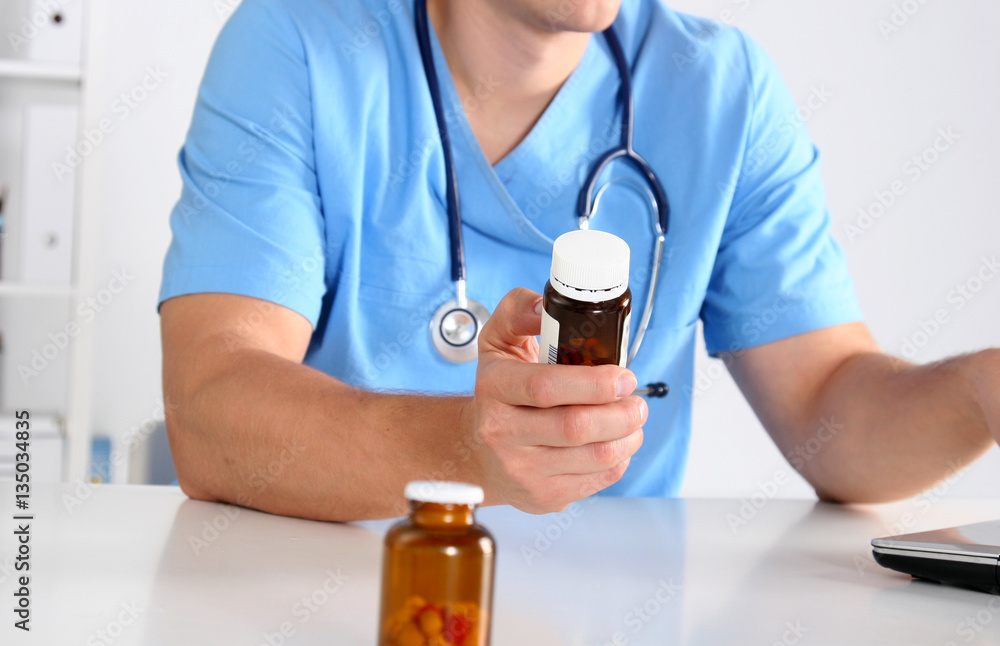 Hand of doctors holding many different pills Hand of doctors holding many different pills