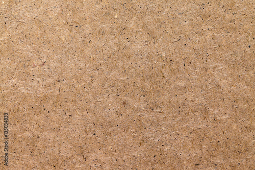 Background of pressed wood fibers texture, light speckled board