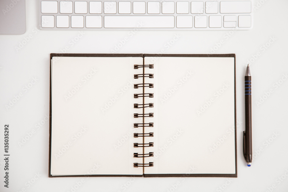 Opened notebook, keyboard on the table Opened notebook, keyboard on the table