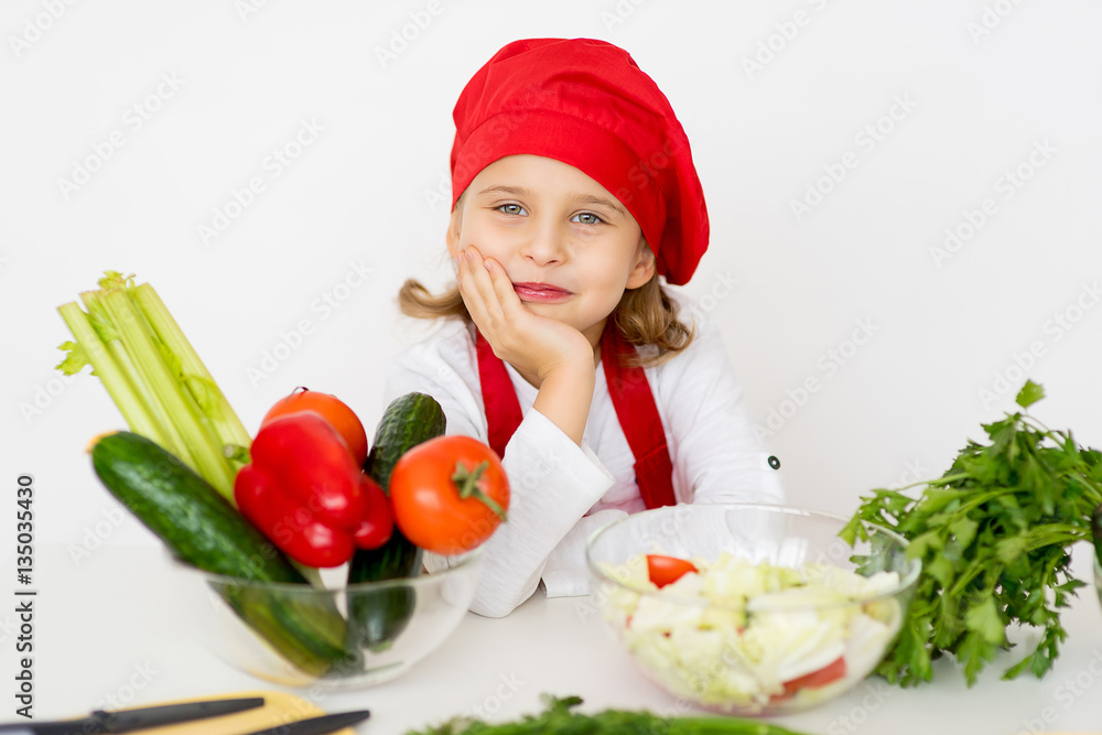 little girl chef is going to prepare a salad isolated little girl chef is going to prepare a salad isolated